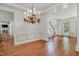 Open-concept dining area with hardwood floors and access to the entryway and kitchen at 123 W Camden Forest Dr, Cary, NC 27518