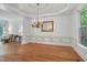 Formal dining room with hardwood floors, wainscoting, and a decorative chandelier at 123 W Camden Forest Dr, Cary, NC 27518