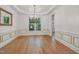 Dining area featuring hardwood floors, decorative wainscoting, and a large window at 123 W Camden Forest Dr, Cary, NC 27518