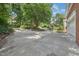 Wide concrete driveway with mature landscaping and a view of the home and garage at 123 W Camden Forest Dr, Cary, NC 27518