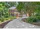 Charming brick home with mature trees and a well-manicured lawn, providing a welcoming curb appeal at 123 W Camden Forest Dr, Cary, NC 27518