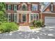 Inviting front entrance with brick steps, black shutters, and tasteful landscaping enhancing curb appeal at 123 W Camden Forest Dr, Cary, NC 27518