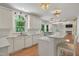 Bright kitchen featuring white cabinets, quartz countertops, and stainless steel appliances at 123 W Camden Forest Dr, Cary, NC 27518