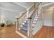 Classic staircase with wooden banister and patterned carpet, adding character to the home's interior at 123 W Camden Forest Dr, Cary, NC 27518