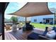 Relaxing backyard deck area with a shade sail, outdoor seating, a fire pit, and a hot tub for ultimate comfort at 1254 Salters St, Burlington, NC 27215