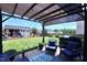 Relaxing backyard patio with comfortable seating, a pergola, and a view of the lush green lawn and outdoor grilling area at 1254 Salters St, Burlington, NC 27215