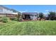 Spacious backyard with a well-maintained lawn, fenced perimeter, and a custom shed and deck entertainment area at 1254 Salters St, Burlington, NC 27215