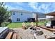 Large backyard with a well-manicured lawn, a fire pit area, and a stylish shed and deck, perfect for entertaining at 1254 Salters St, Burlington, NC 27215