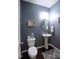Stylish powder room featuring a pedestal sink, charming decor, and a modern toilet at 1254 Salters St, Burlington, NC 27215