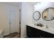 Well-lit bathroom featuring a double sink vanity with modern fixtures and black trim at 1254 Salters St, Burlington, NC 27215
