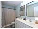 Well-lit bathroom features a double sink vanity and a shower with a patterned curtain at 1254 Salters St, Burlington, NC 27215