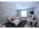 Cozy bedroom with a plush rug, soft pink bedding, and a window offering natural light at 1254 Salters St, Burlington, NC 27215