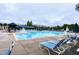 Large community pool features lap lanes, lounge chairs, and shaded seating areas for residents to enjoy at 1254 Salters St, Burlington, NC 27215