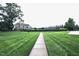 Exterior view of landscaped lawn leading to clubhouse, tennis and volleyball courts at 1254 Salters St, Burlington, NC 27215