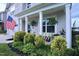 Cozy front porch with decorative plants and comfortable seating, perfect for relaxing outdoors at 1254 Salters St, Burlington, NC 27215