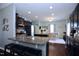 Modern kitchen with dark cabinets, stainless steel appliances, granite countertops, and an island with bar stool seating at 1254 Salters St, Burlington, NC 27215
