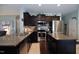 Modern kitchen with stainless steel appliances, granite countertops, a center island, and dark cabinets at 1254 Salters St, Burlington, NC 27215