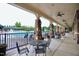 Outdoor pool area featuring lounge seating and covered patio with stone columns and ceiling fans at 1254 Salters St, Burlington, NC 27215