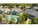 Aerial view of townhouses with a community pool surrounded by lush greenery at 1313 Legacy Greene Ave, Wake Forest, NC 27587