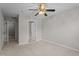 A bright, carpeted bedroom featuring a ceiling fan and a closet at 1313 Legacy Greene Ave, Wake Forest, NC 27587