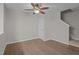 A simple bedroom with wood floors, a ceiling fan, and a white door at 1313 Legacy Greene Ave, Wake Forest, NC 27587