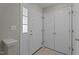 Clean entryway with white doors, tile flooring, and natural light at 1313 Legacy Greene Ave, Wake Forest, NC 27587