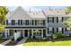 Charming townhouse featuring gray siding, black shutters, and a well-manicured front yard at 1313 Legacy Greene Ave, Wake Forest, NC 27587