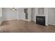 Bright living room with laminate floors, fireplace, and stairs at 1313 Legacy Greene Ave, Wake Forest, NC 27587