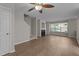 Cozy living room featuring wood floors, a fireplace, and natural light from the window at 1313 Legacy Greene Ave, Wake Forest, NC 27587