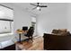 Spacious bedroom featuring laminate flooring, ceiling fan, and a large window at 136 Hatchet Cv, Louisburg, NC 27549