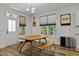 Bright dining room with modern table and guitar, wood flooring and view to the backyard at 136 Hatchet Cv, Louisburg, NC 27549