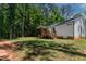 A shot of the back of the house with a screened-in porch and stairs at 136 Hatchet Cv, Louisburg, NC 27549