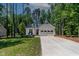 Charming single-story white home with a two-car garage and a well-manicured front yard at 136 Hatchet Cv, Louisburg, NC 27549