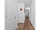 Long hallway featuring stylish vinyl floors and neutral paint at 136 Hatchet Cv, Louisburg, NC 27549