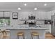 Close-up of the white kitchen featuring stainless steel appliances and granite countertops at 136 Hatchet Cv, Louisburg, NC 27549