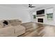 A cozy living room features a fireplace, large TV, and comfortable beige sectional at 136 Hatchet Cv, Louisburg, NC 27549