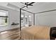 A serene main bedroom features a canopy bed, hardwood floors, and ample natural light at 136 Hatchet Cv, Louisburg, NC 27549