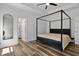 This main bedroom features a four-poster bed frame and modern fixtures at 136 Hatchet Cv, Louisburg, NC 27549