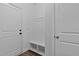 A clean, white mudroom has a built-in bench with storage for added organization at 136 Hatchet Cv, Louisburg, NC 27549