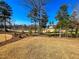 Backyard view of a golf course and pond on a sunny day at 14 Duck Bill Trl, Pittsboro, NC 27312