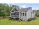 Exterior of house with landscaped backyard and screened porch at 14 Duck Bill Trl, Pittsboro, NC 27312