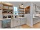 Stylish bar area with custom shelving, a wine fridge, and elegant decor at 14 Duck Bill Trl, Pittsboro, NC 27312