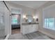 Bathroom featuring modern fixtures, vanity with storage, and view to the main bedroom at 14 Duck Bill Trl, Pittsboro, NC 27312