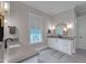 Bathroom featuring modern fixtures, vanity with storage, and natural light at 14 Duck Bill Trl, Pittsboro, NC 27312