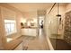 Modern bathroom with a glass-enclosed shower, vanity, and patterned rug at 14 Duck Bill Trl, Pittsboro, NC 27312