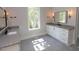 Bright bathroom with double vanities and lots of natural light at 14 Duck Bill Trl, Pittsboro, NC 27312