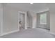 Bedroom featuring neutral carpet, window, and door access to the rest of the house at 14 Duck Bill Trl, Pittsboro, NC 27312