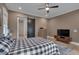 Comfortable bedroom features a ceiling fan, barn door and windows with natural light at 14 Duck Bill Trl, Pittsboro, NC 27312