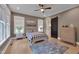 Comfortable bedroom features wood floors, ceiling fan, barn door and windows with natural light at 14 Duck Bill Trl, Pittsboro, NC 27312