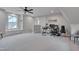 Spacious bonus room featuring carpet, a ceiling fan, a window bench, and an office area with dual monitors at 14 Duck Bill Trl, Pittsboro, NC 27312